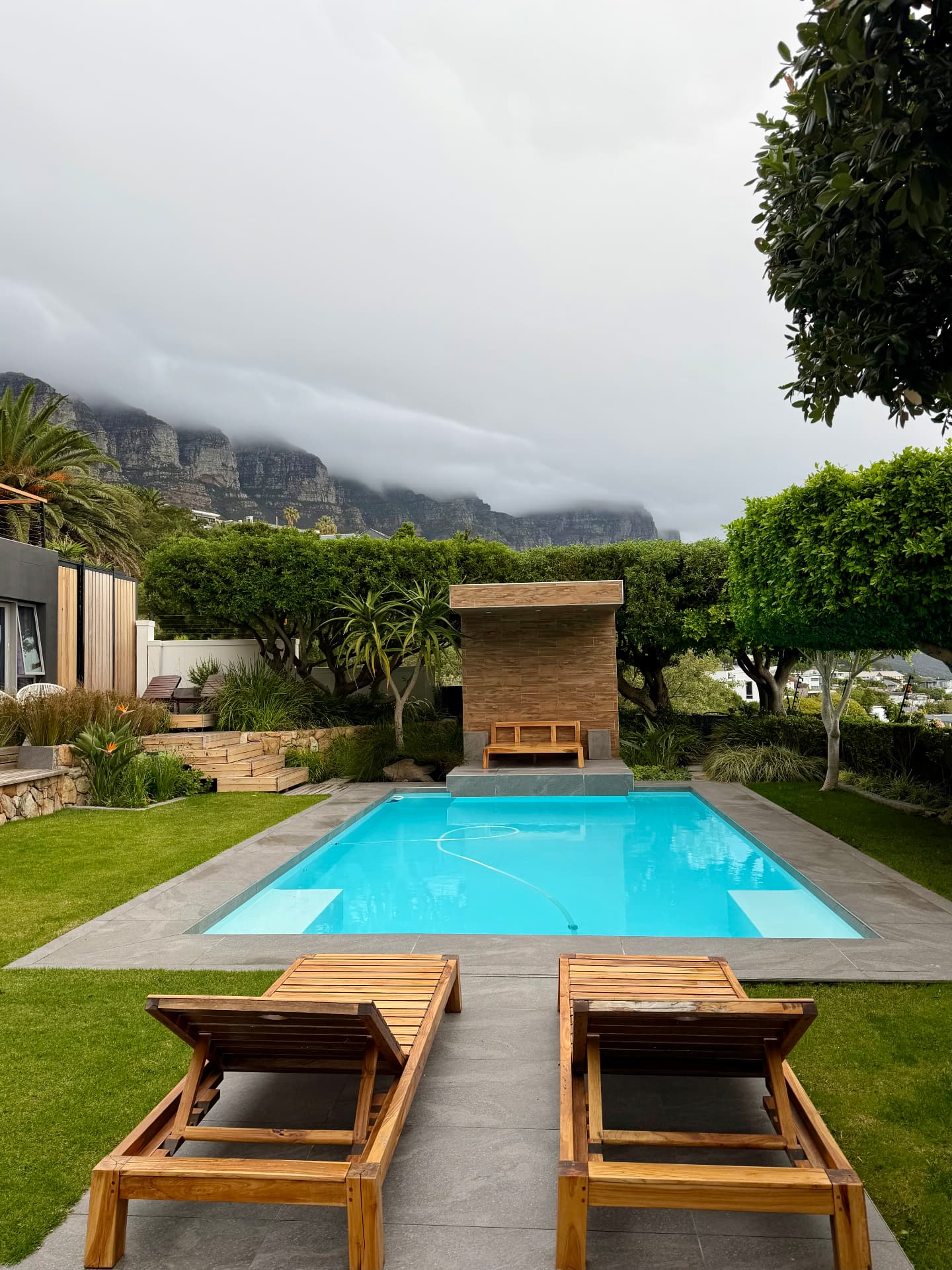 Pool terrace beneath cloud spilling over the Twelve Apostles, Cape Town